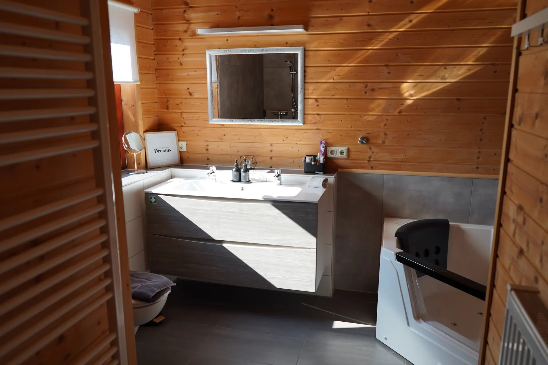 Bathroom at Holiday Home Annika with a washbasin, mirror and whirlpool bath